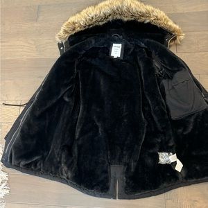 Womens winter hooded jacket .  In black . Faux fur trim on the hood